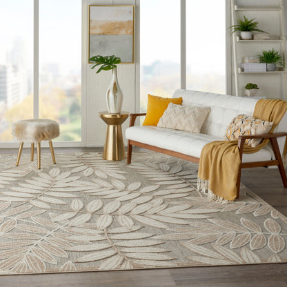 Bright modern living room with white sofa, wooden arms, mustard cushions, gold side table, tropical leaf-pattern rug, fur stool.