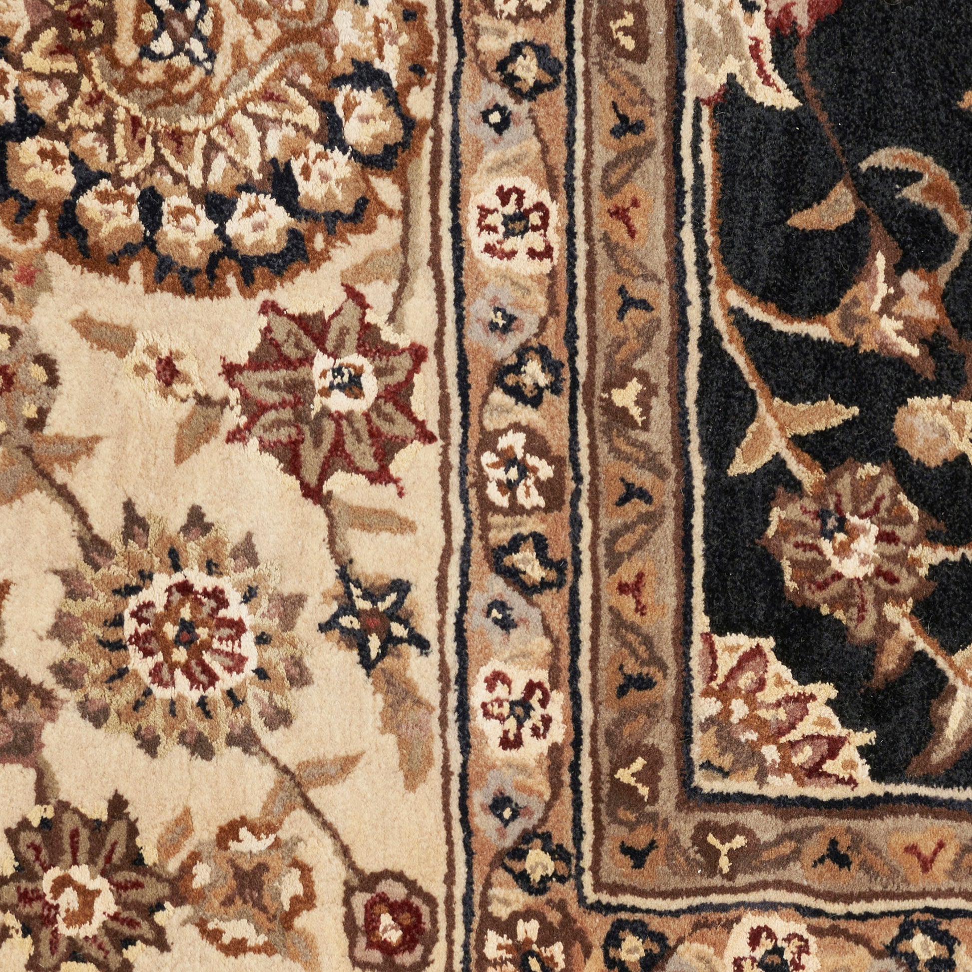 Traditional Persian-style rug close-up: cream field with red and blue floral motifs, tan border and dark outer border.