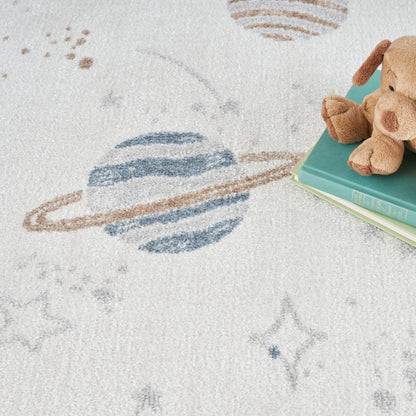 Brown plush teddy bear resting on teal & mint books on a soft white space-pattern rug with planets & stars.