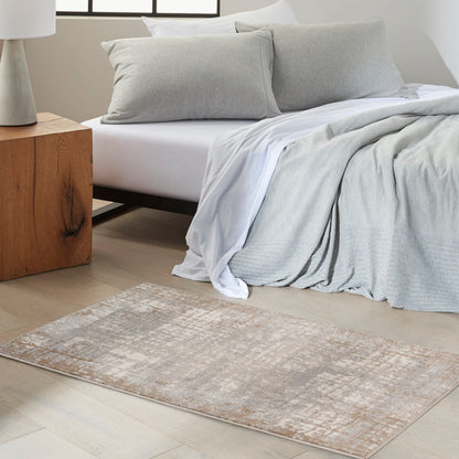 Neutral bedroom with light grey bedding, white sheets, soft grey pillows, beige patterned rug, and wooden block nightstand.