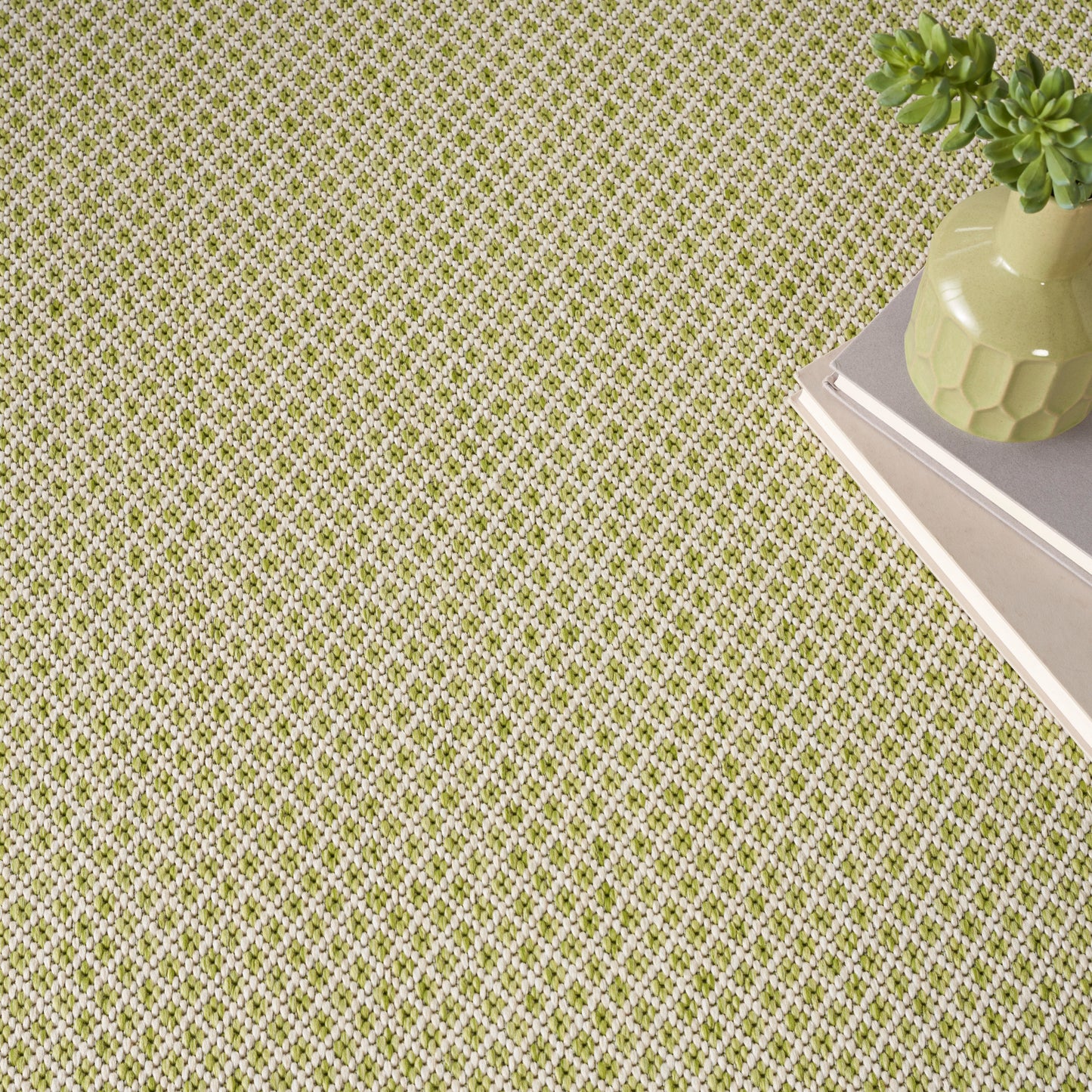 Green and white lattice-pattern rug on the floor; modern geometric style.