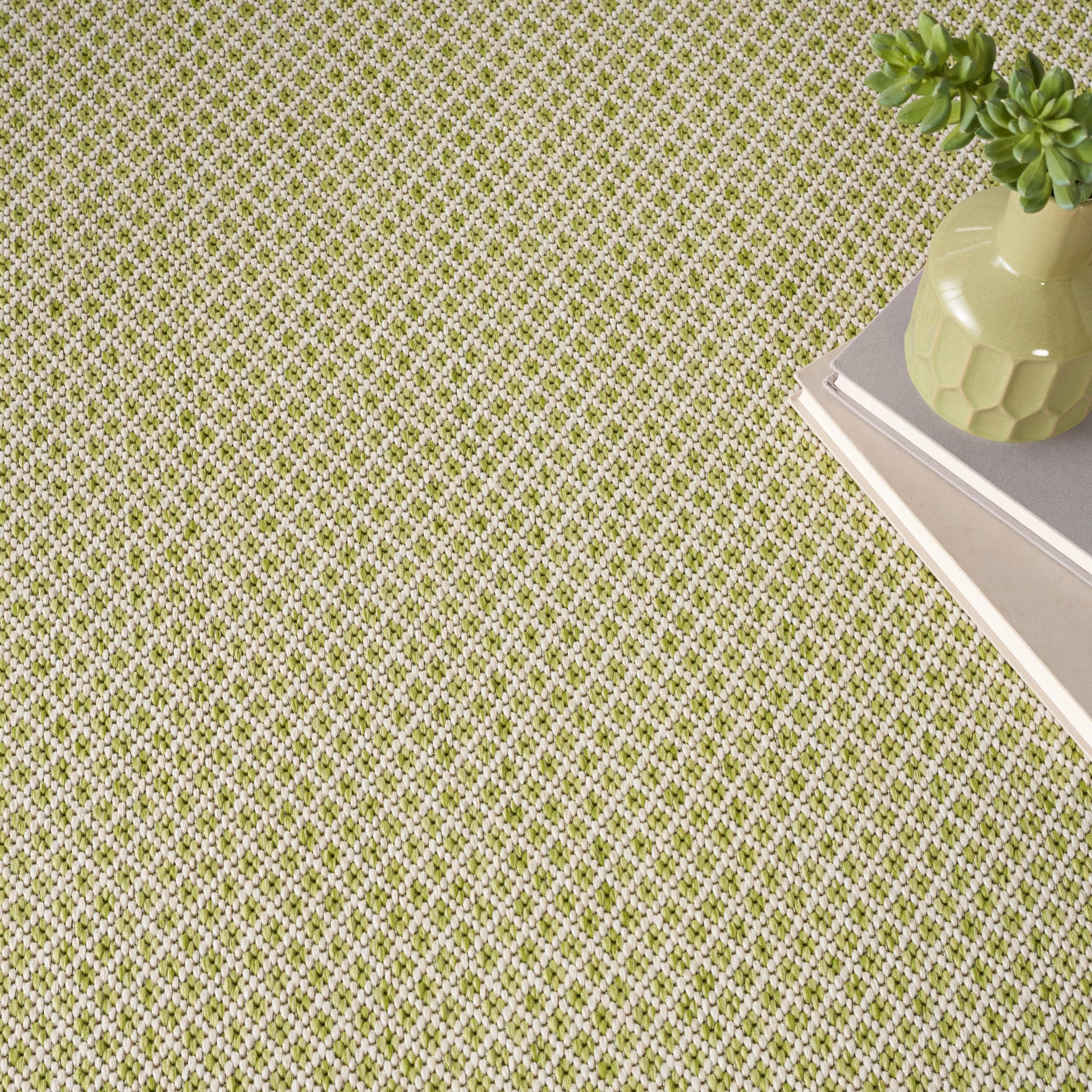 Green and white lattice-pattern rug on the floor; modern geometric style.