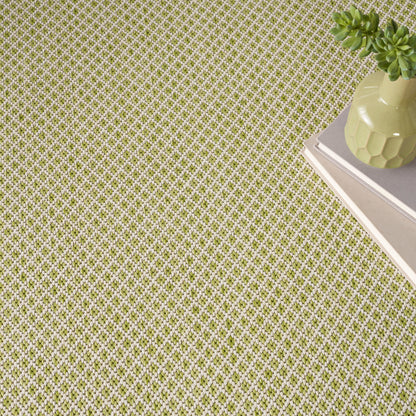 Green and white lattice-pattern rug on the floor; modern geometric style.