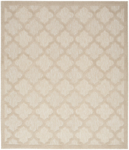 Beige area rug with a subtle trellis/quatrefoil lattice in a textured woven surface.