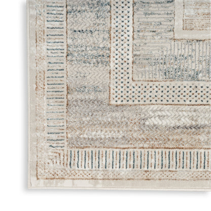 Corner view of a beige and ivory woven runner with blue-gray geometric borders and layered rectangular motifs.
