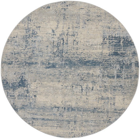 Round area rug in blue and beige with distressed abstract pattern, modern coastal decor.