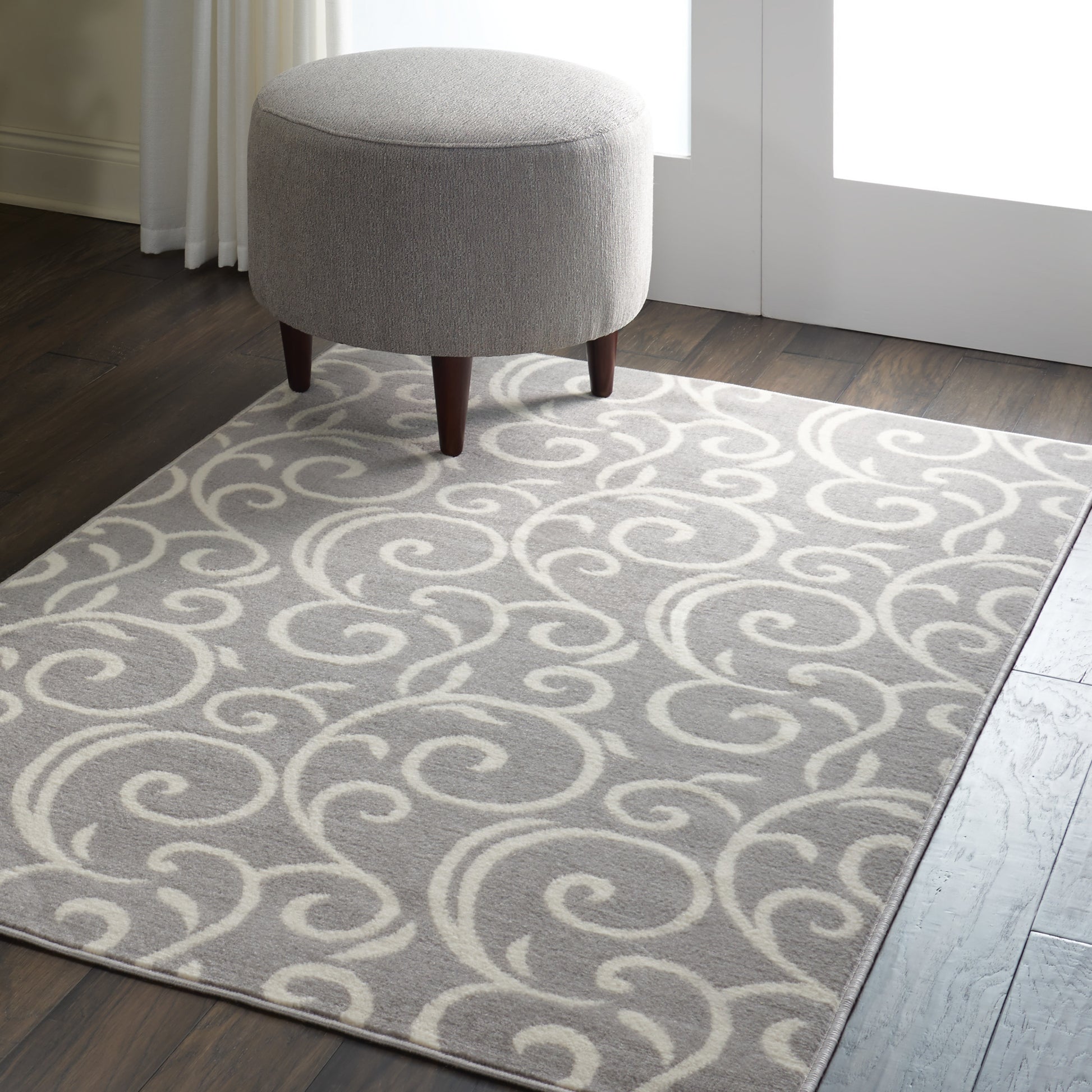 Light gray rug with cream swirls in a modern living space (4' x 6').