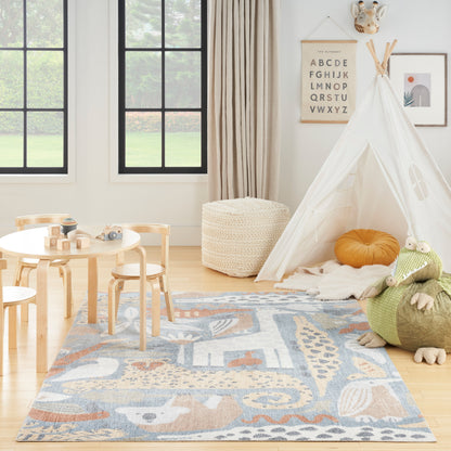 Bright kids' playroom with white teepee, blue patterned rug, wooden table and chairs, woven pouf; cozy Scandinavian style.