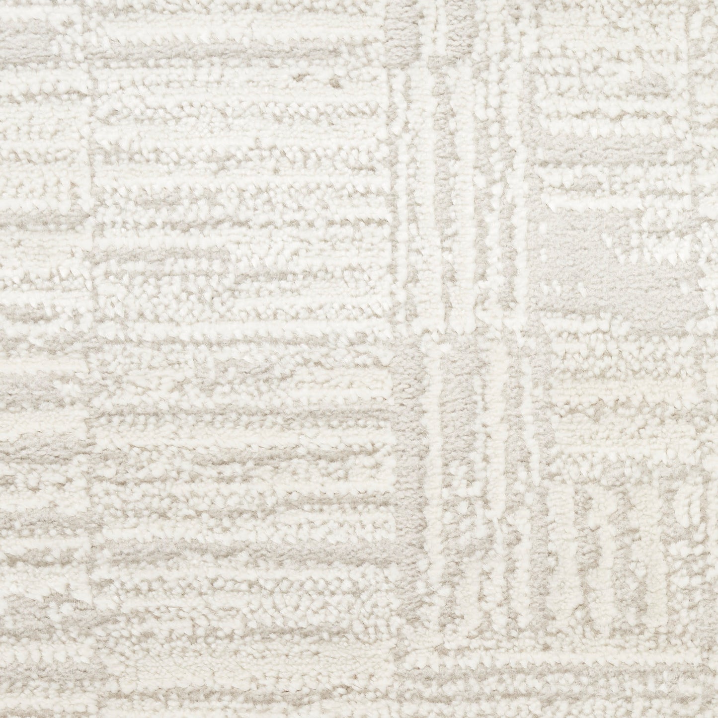 Cream and ivory geometric rug with raised tufted pattern and plush, textured pile.