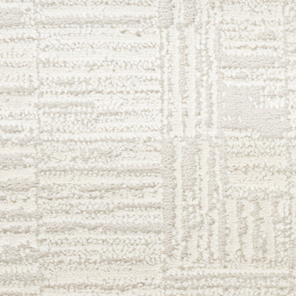 Cream and ivory geometric rug with raised tufted pattern and plush, textured pile.