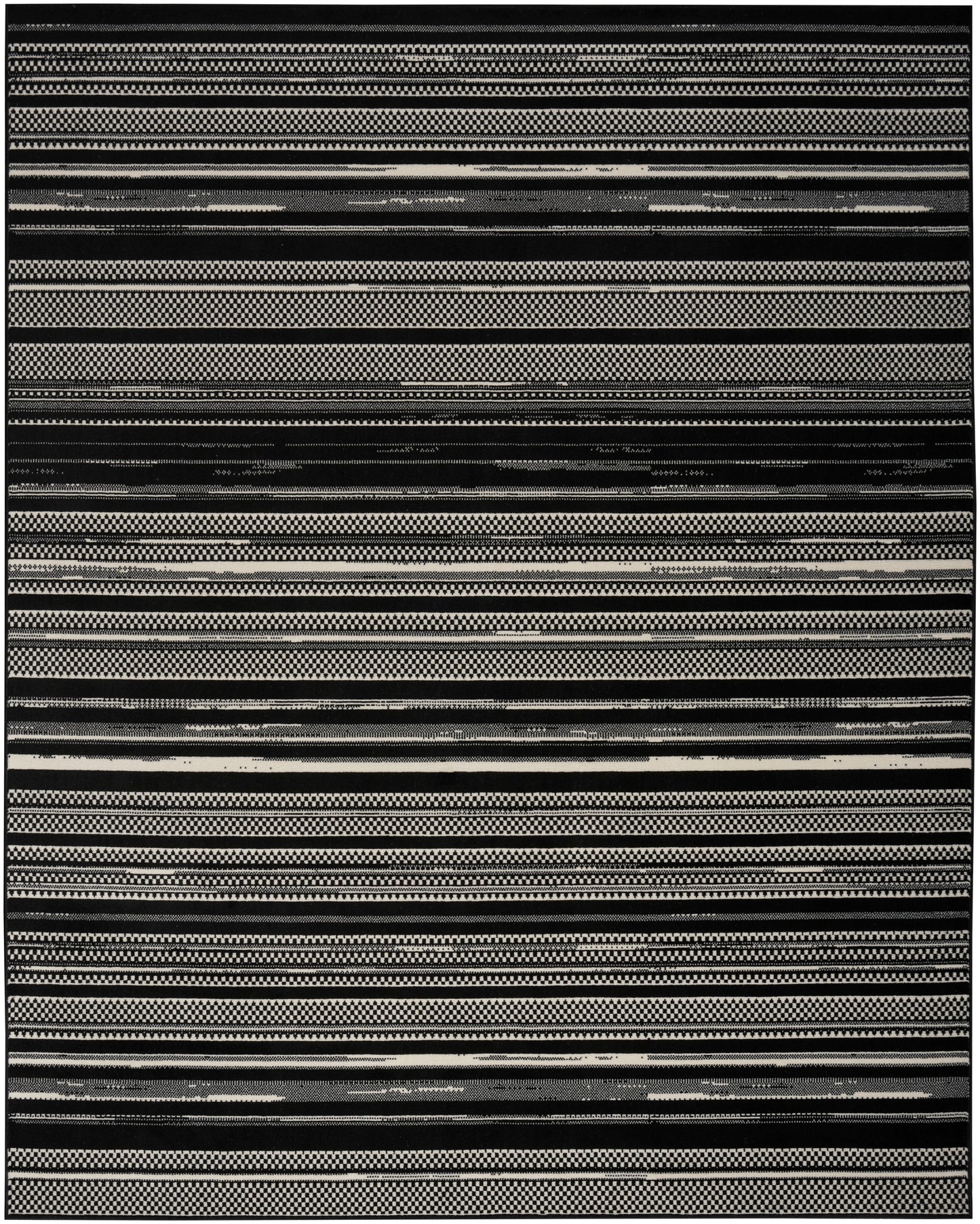Black and white striped woven rug with varied geometric bands; rectangular, modern tribal style.