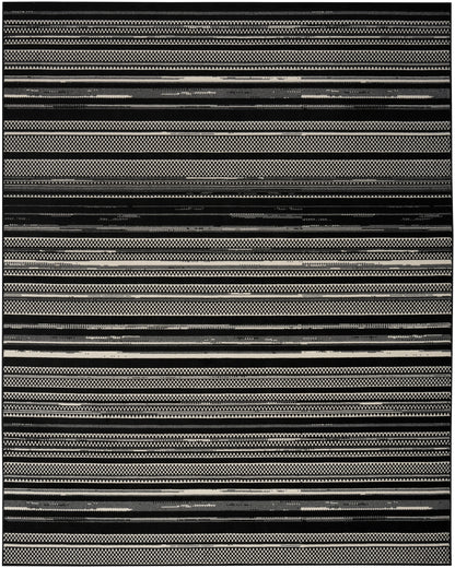Black and white striped woven rug with varied geometric bands; rectangular, modern tribal style.
