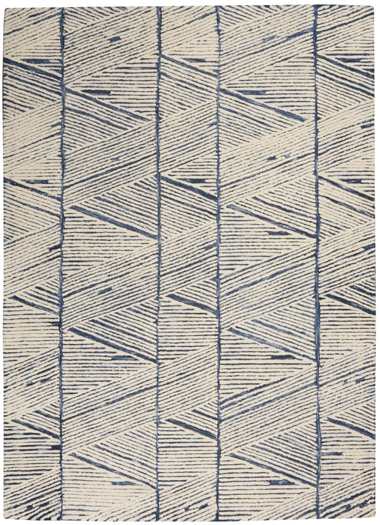 Cream and navy geometric area rug with repeating triangles and chevron shapes in vertical bands.