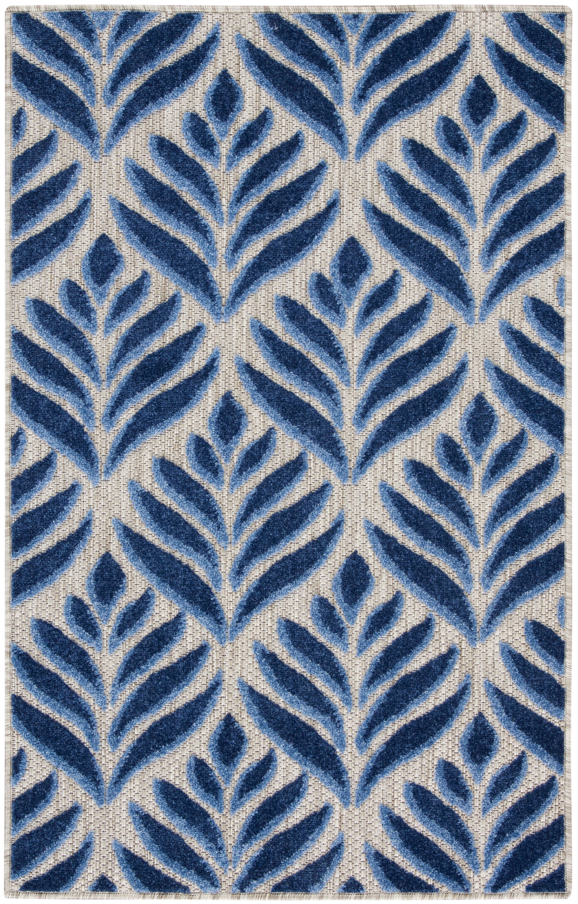 Rectangular tufted rug with navy blue fern-like leaf motifs on a beige woven ground; modern botanical decor for living room.