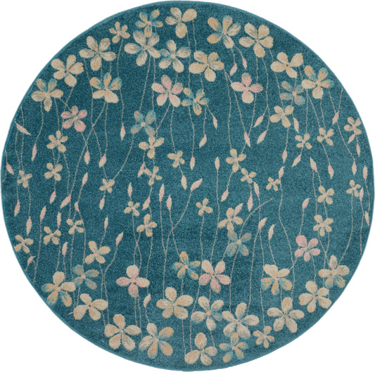 Round teal rug featuring cream and pink floral pattern with slender stems.