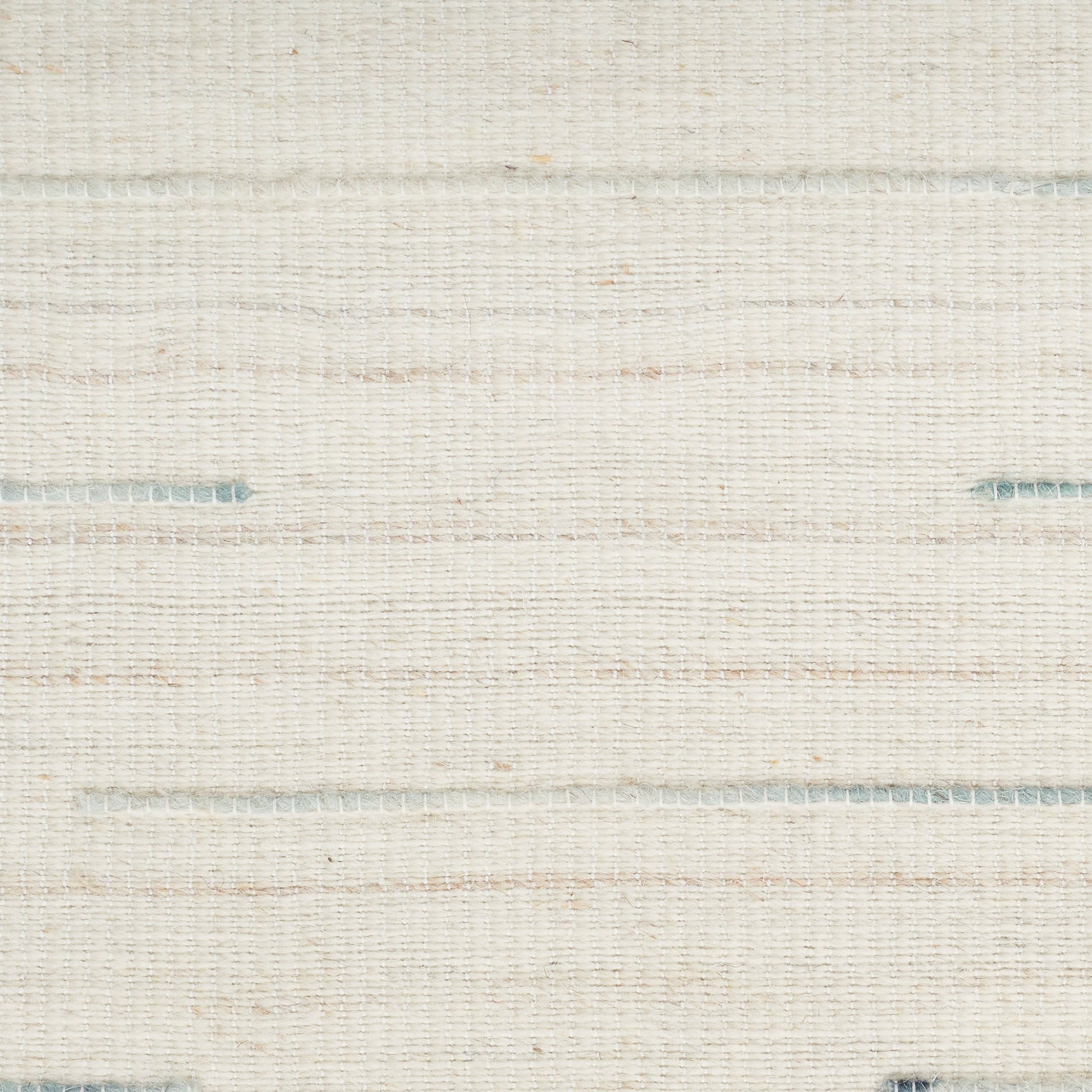 Cream woven rug texture with subtle blue horizontal threads; linen-style rug for home decor