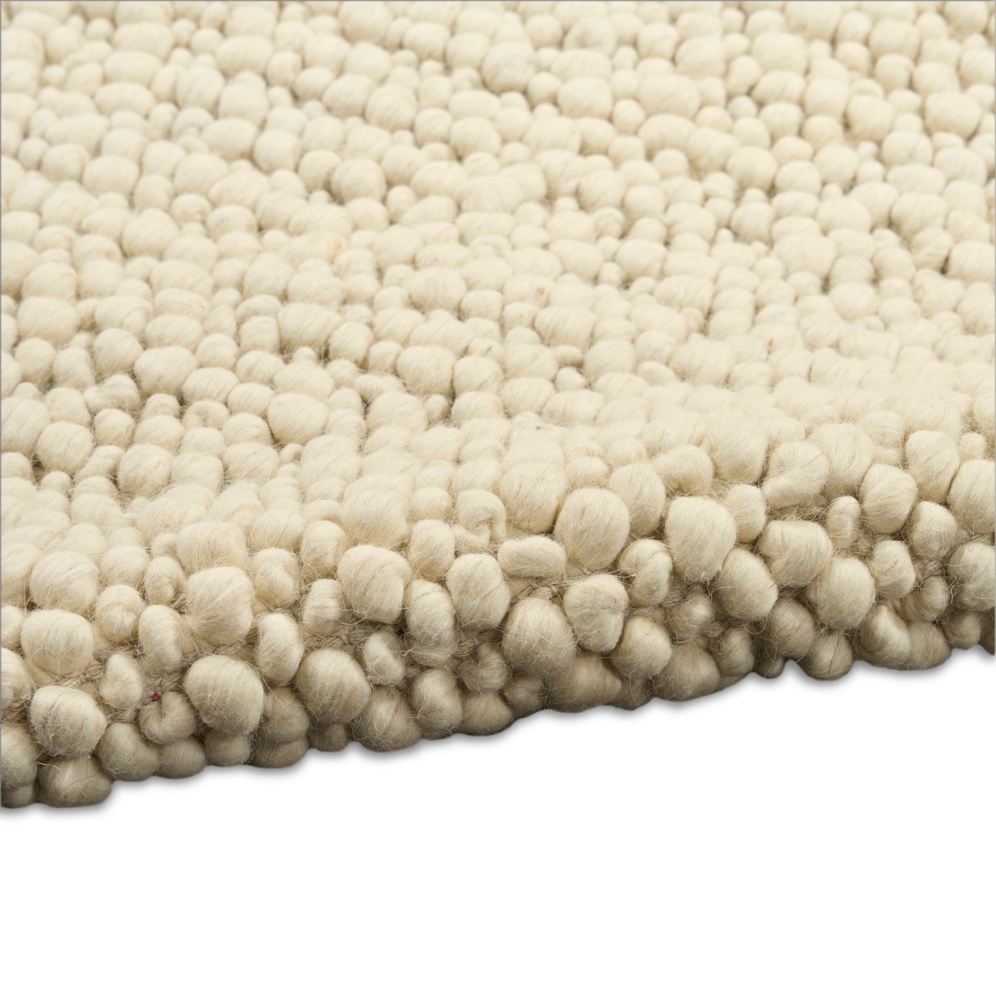 Cream shag rug with dense, round-tufted bubbles and soft wool texture.