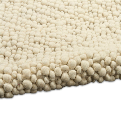 Cream shag rug with dense, round-tufted bubbles and soft wool texture.
