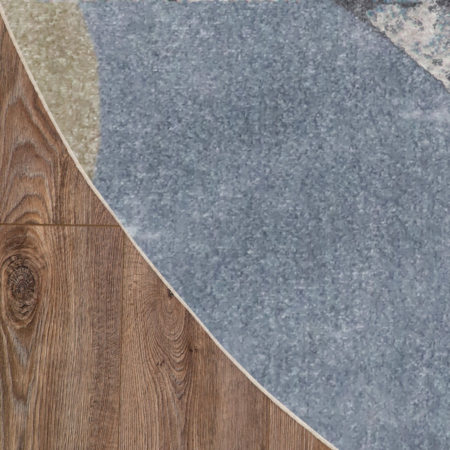 Blue-gray circular rug partially over brown wood planks, curved edge with white border.