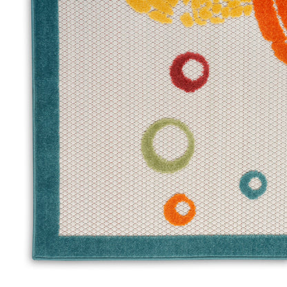 Teal-framed cream woven rug with multicolor ring motifs in red, green, orange and teal; textured weave.