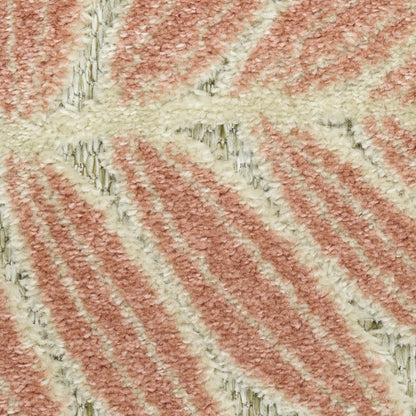 Close-up of a pink and cream striped shag rug with soft, plush pile and diagonal chevron pattern.