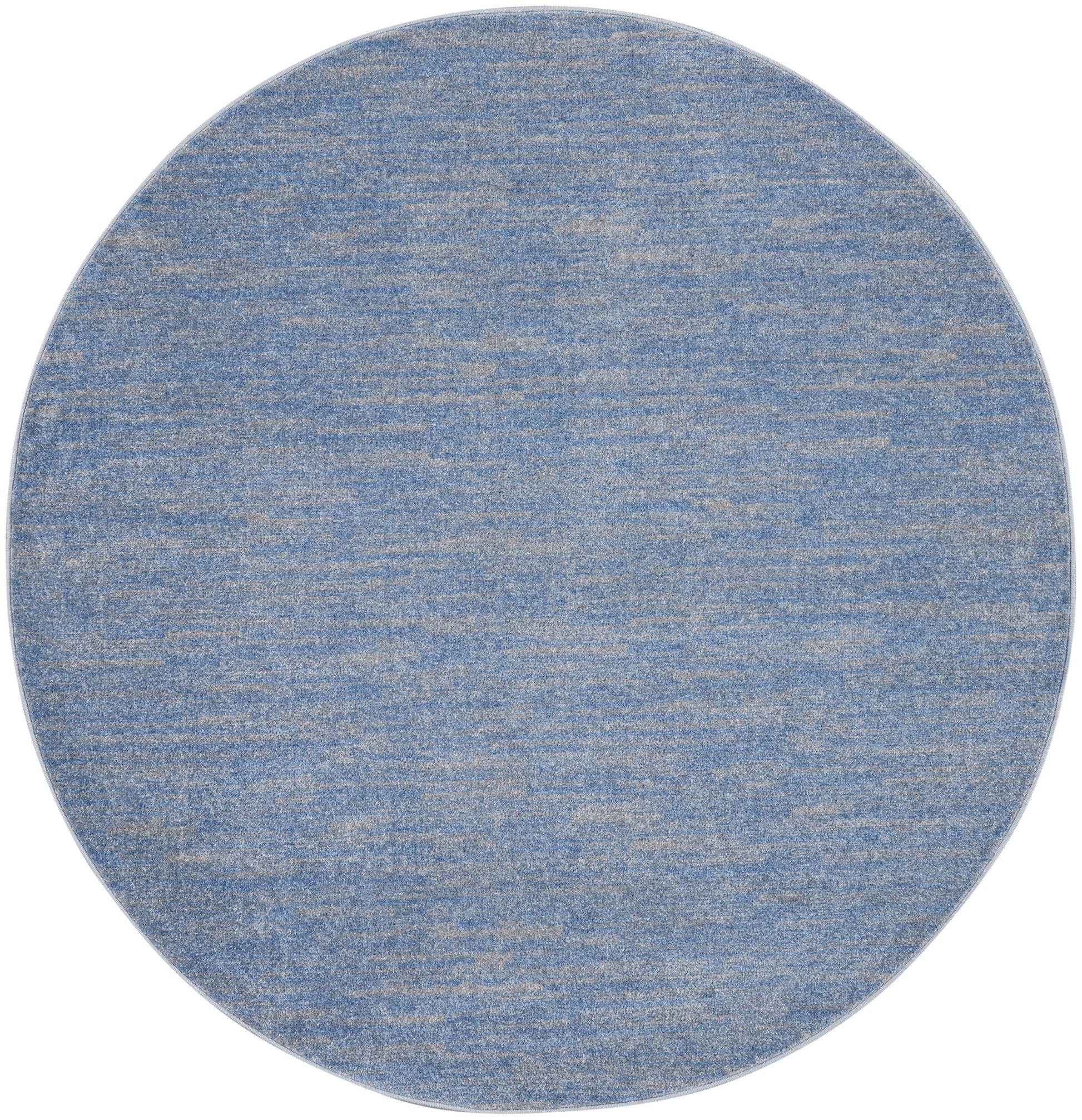 Round blue textured rug with marled denim finish and beige flecks.