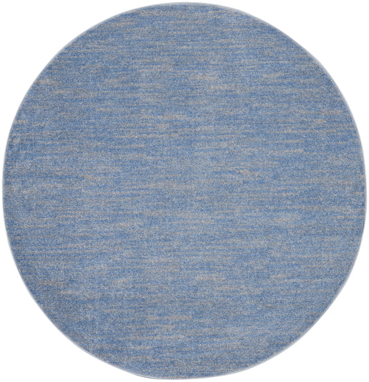 Round blue textured rug with marled denim finish and beige flecks.
