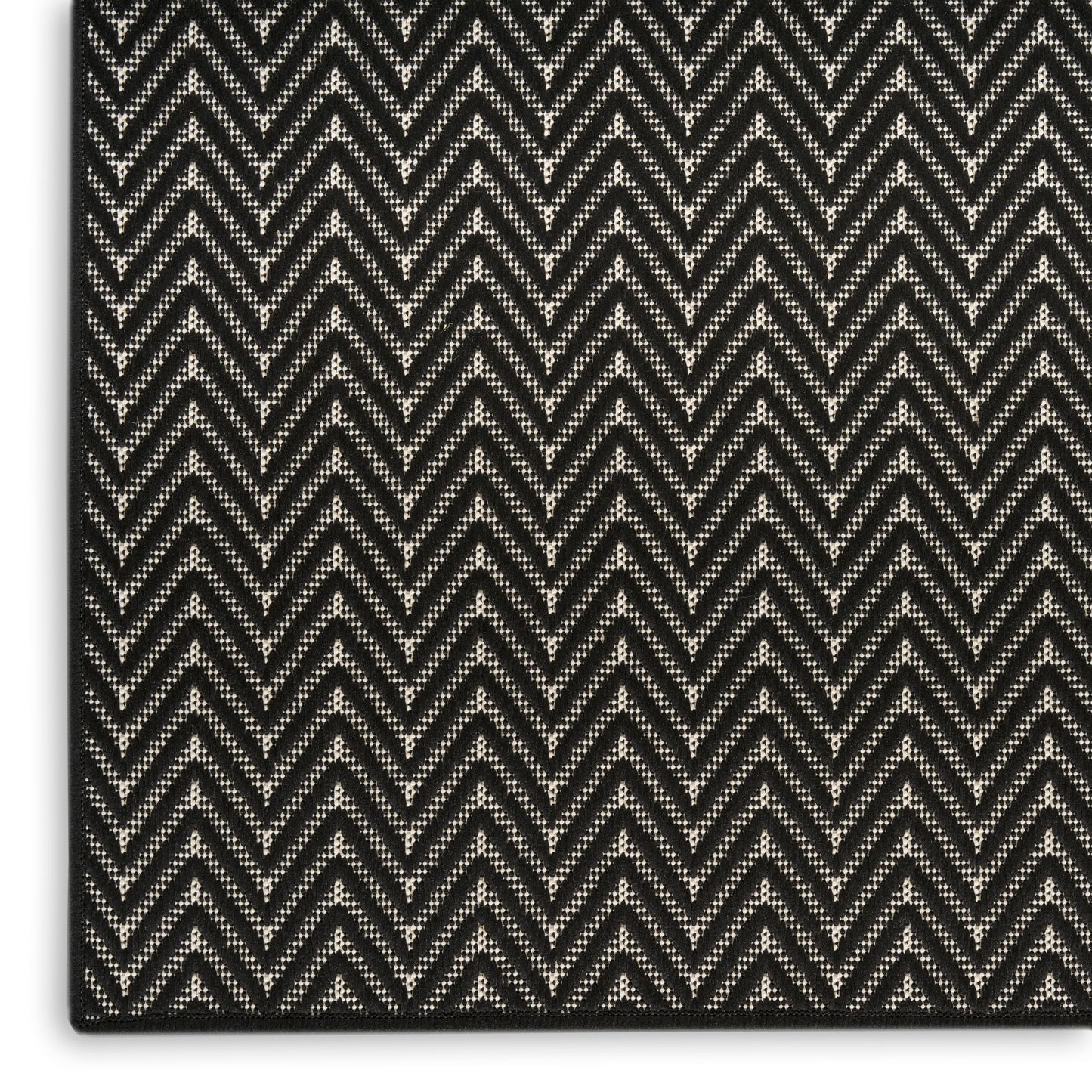 Close-up of black and white chevron woven fabric with textured zigzag pattern.