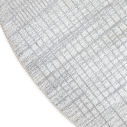 Grey and white textured rug with a subtle geometric grid pattern and curved edge.