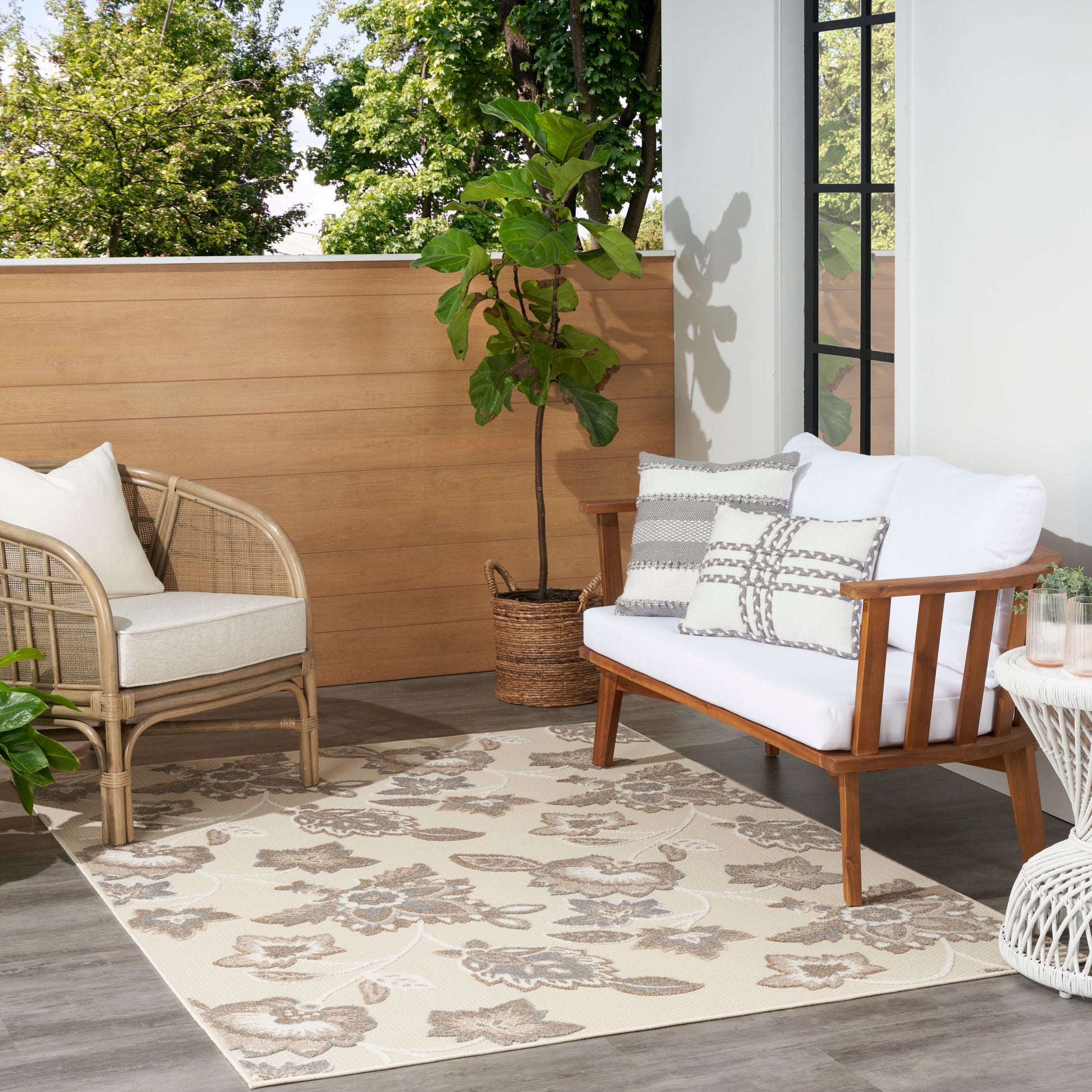 Beige floral area rug 4' x 6' with a potted plant nearby.