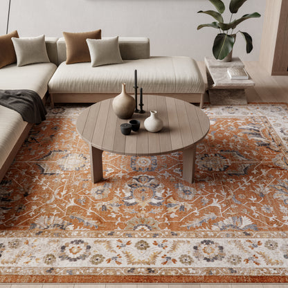Round wooden coffee table with ceramic vases and candle holder on an orange-and-cream oriental rug beneath a beige sectional.