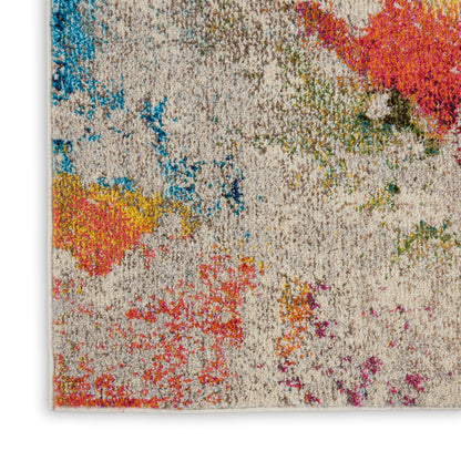 Shaggy rectangular rug with cream base and vivid multicolor abstract patches in blue, pink, yellow, orange and green.