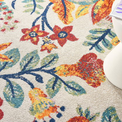Close-up of a beige floral rug with bright red, orange, yellow flowers and blue-green leaves; textured pile.