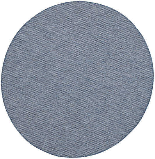 Round blue denim-textured woven placemat with subtle diagonal weave.