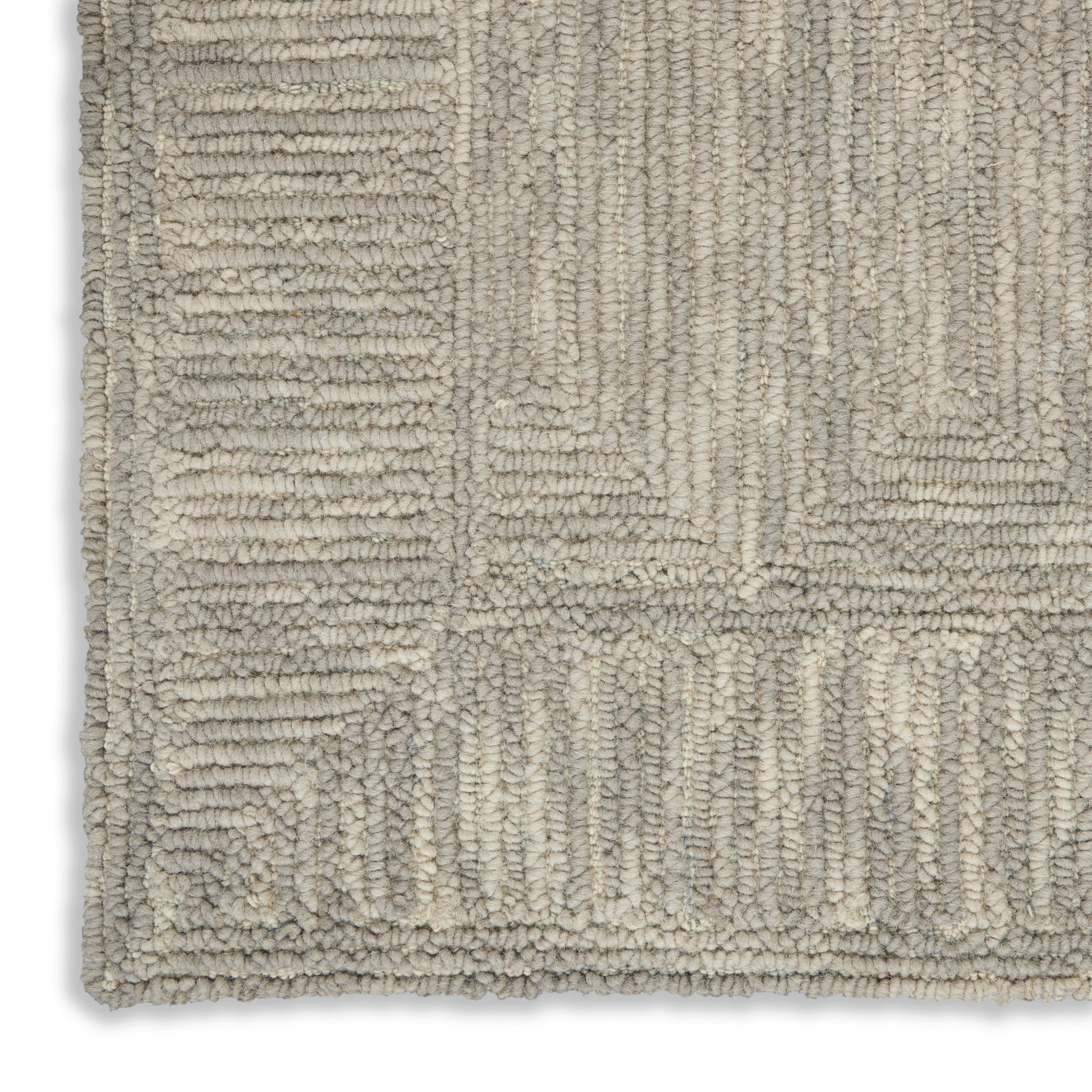 Soft beige and cream tufted rug with geometric rectangular patchwork and a plush, looped pile.
