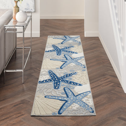 Coastal-themed hallway runner rug, long and narrow, featuring blue starfish and seashells on a light gray background.