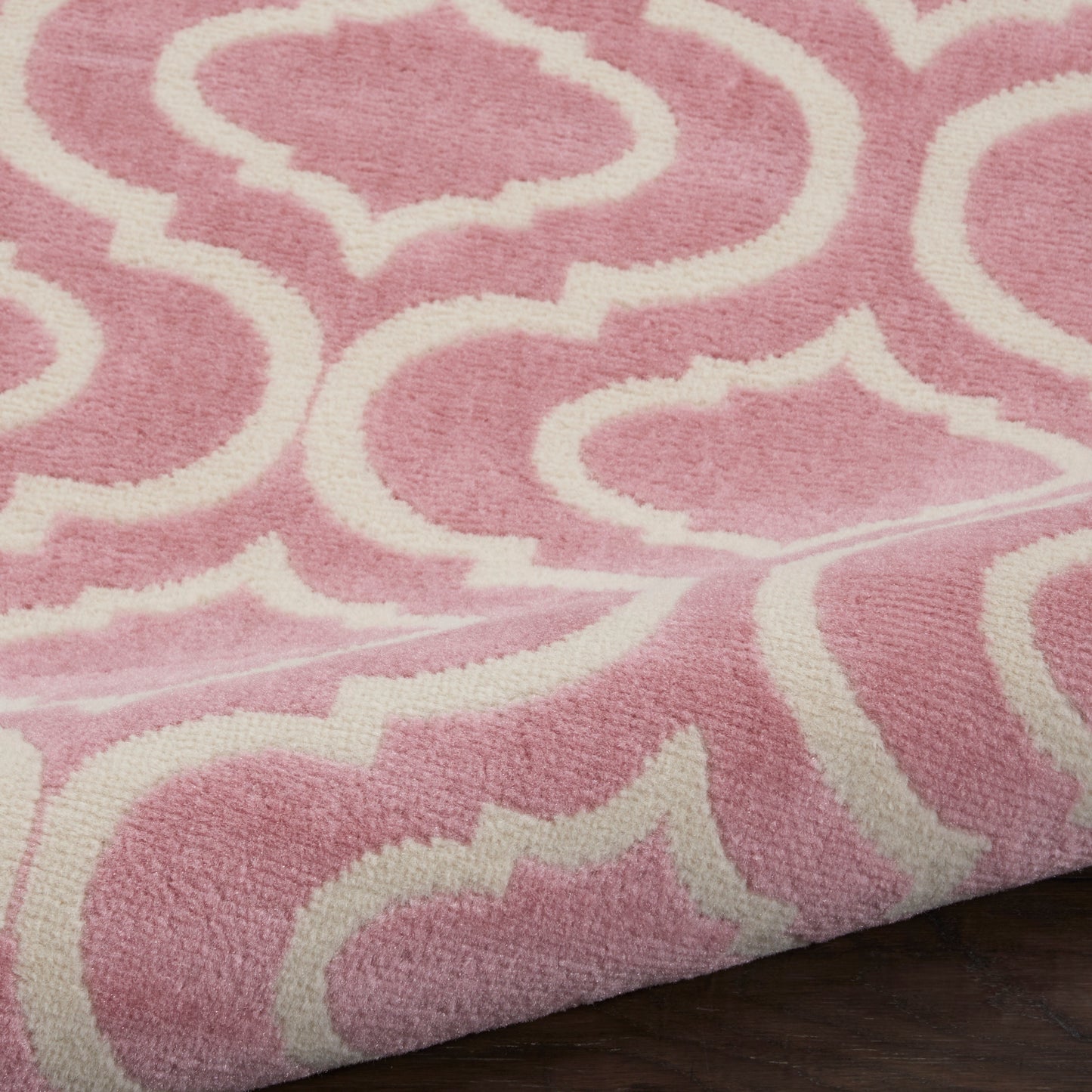 Pink plush 7' runner rug with white geometric trellis pattern; soft shag texture, rectangular home decor accent