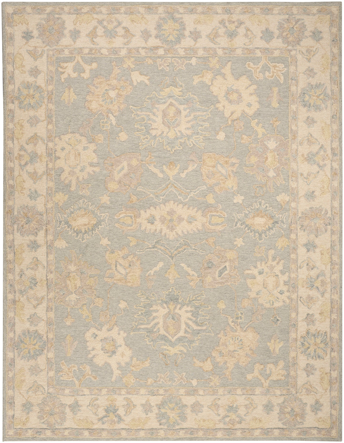Pastel blue area rug with ivory floral medallions and a pale beige ornate border; vintage distressed style.