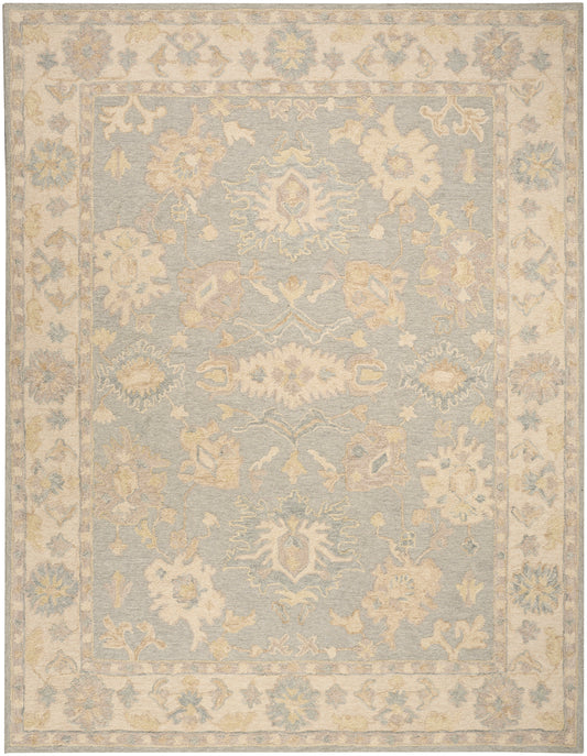 Pastel blue area rug with ivory floral medallions and a pale beige ornate border; vintage distressed style.