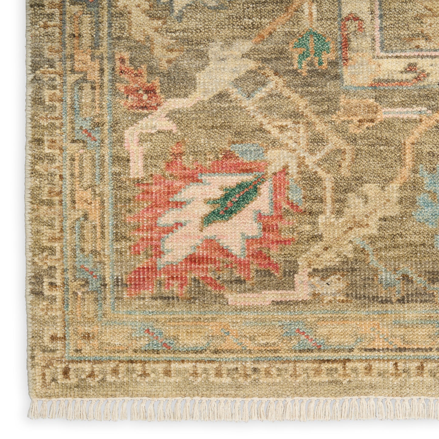 Beige oriental rug with fringe; tan/brown field, blue/green accents, intricate floral medallion border.