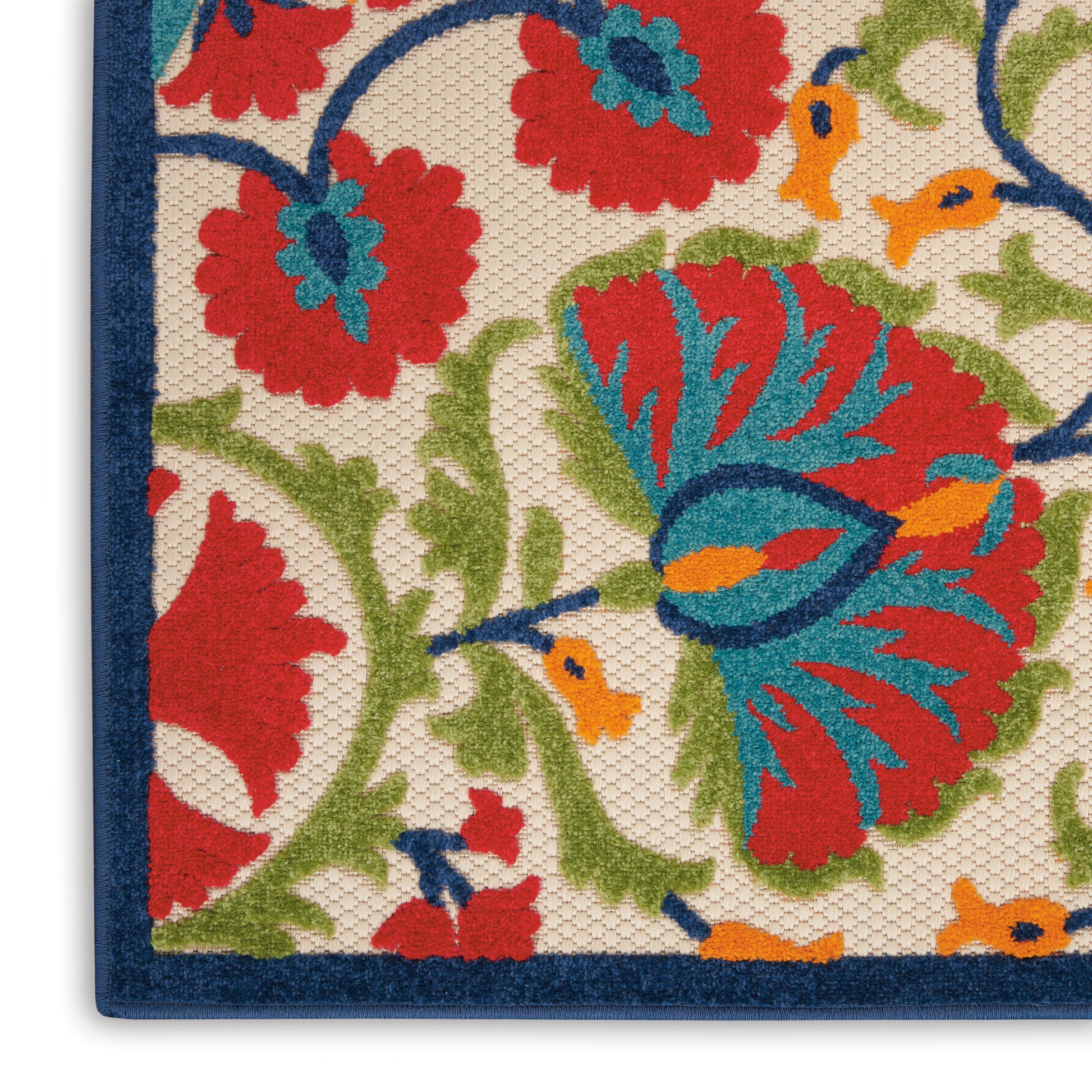 Close-up of a woven floral rug with red, blue, green and orange blossoms on beige, dark blue border.