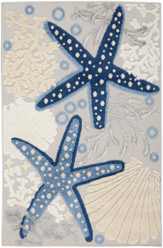 Coastal textured rug with two blue dotted starfish, beige shells and corals on a soft gray-beige background.