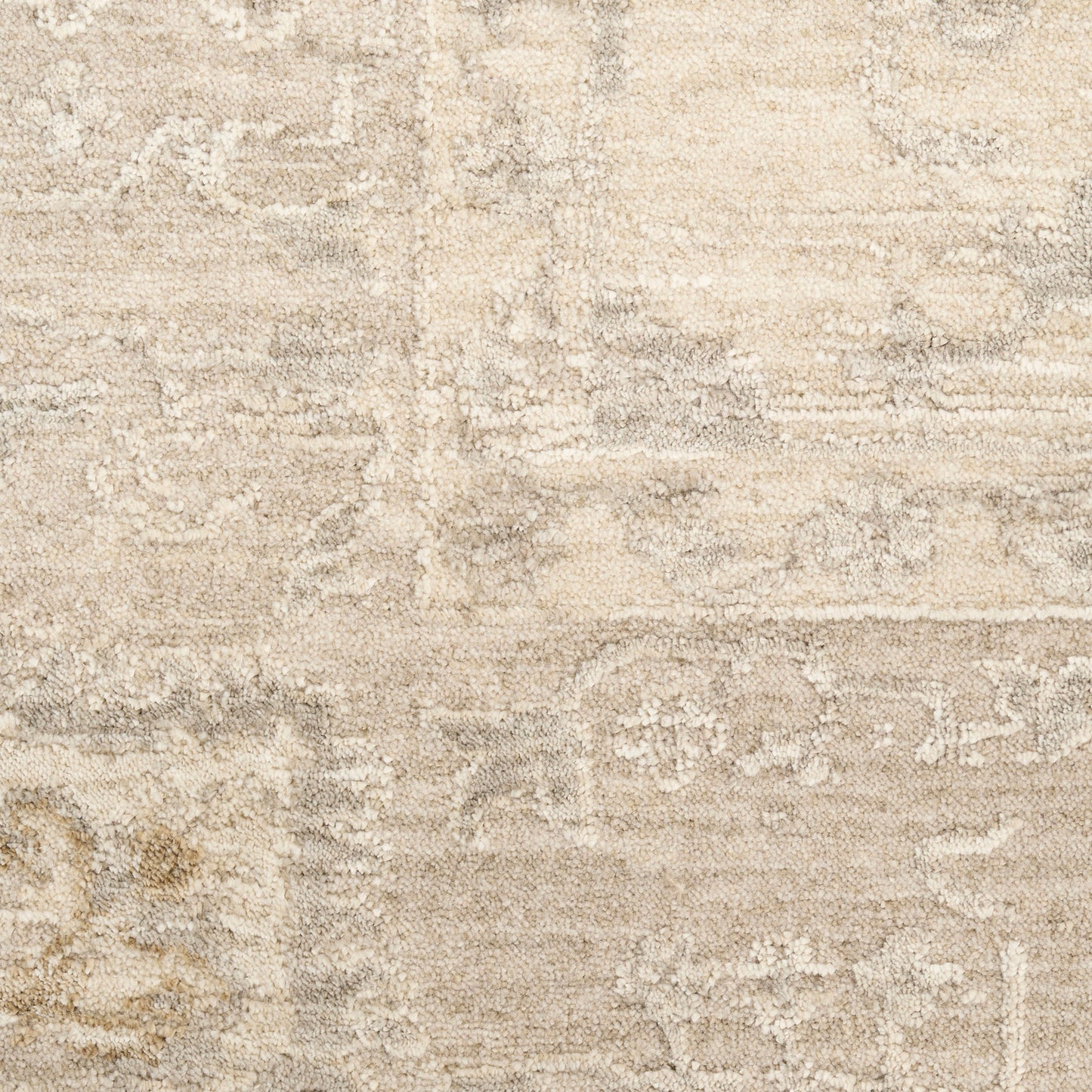 Beige distressed oriental-style area rug with muted gray and cream motifs.