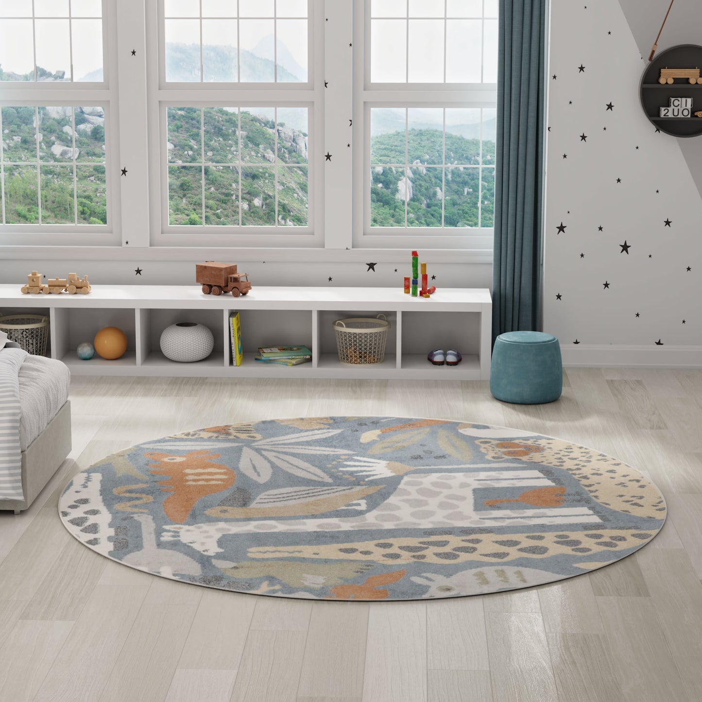 Round abstract-pattern textile rug in blue, gray, beige and orange on a light wood floor in a bright kids' playroom.