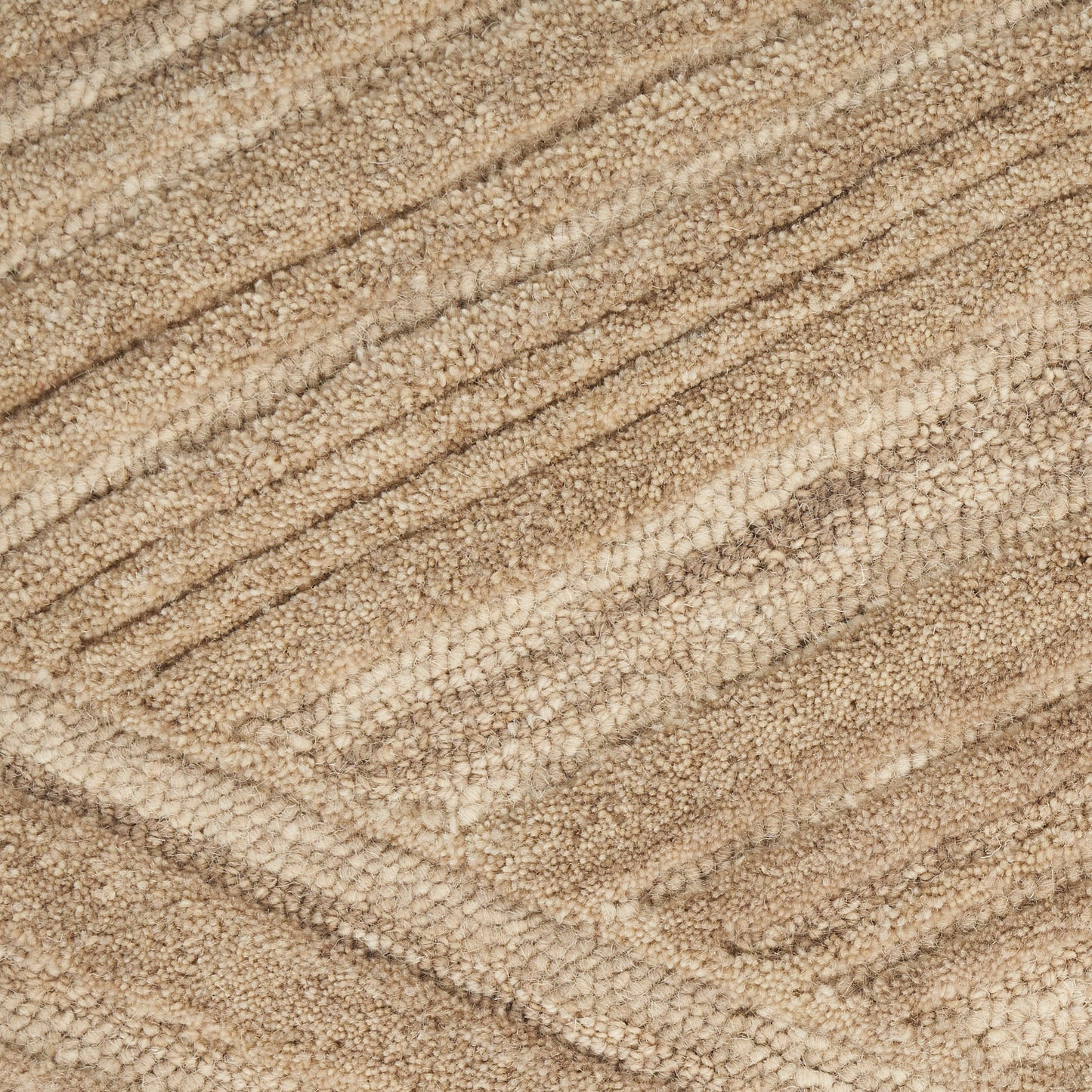 Beige loop-pile rug close-up with diagonal textured stripes and a soft plush surface.
