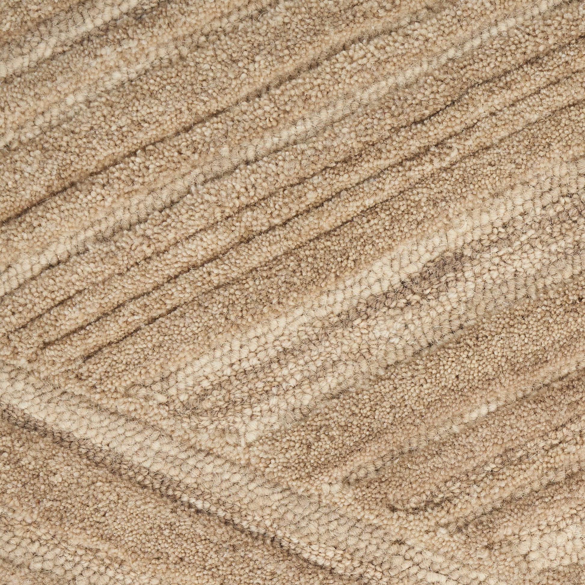 Beige loop-pile rug close-up with diagonal textured stripes and a soft plush surface.