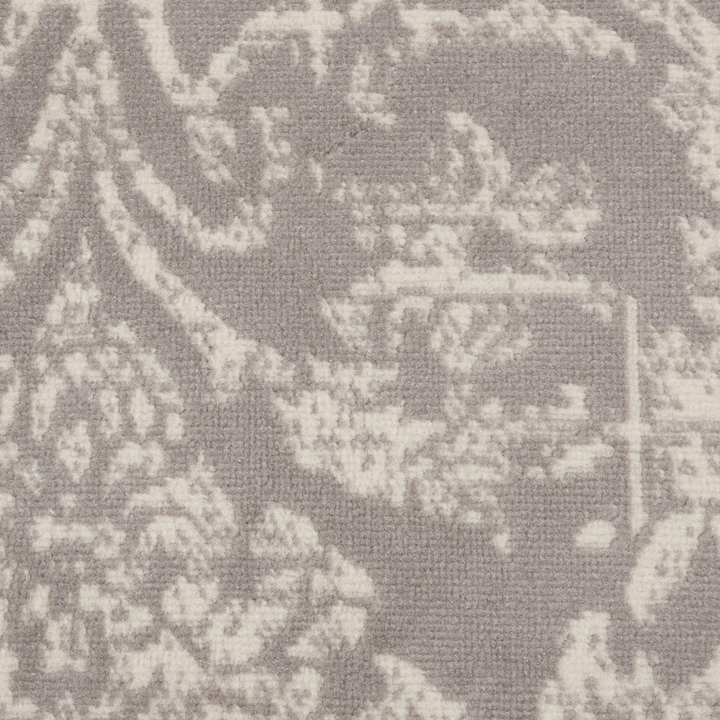 Soft grey damask patterned rug with a pale ivory floral motif; round 5' diameter vintage-style rug.