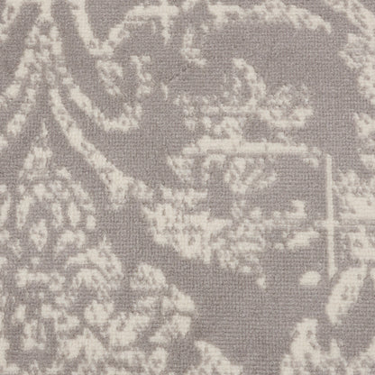 Soft grey damask patterned rug with a pale ivory floral motif; round 5' diameter vintage-style rug.