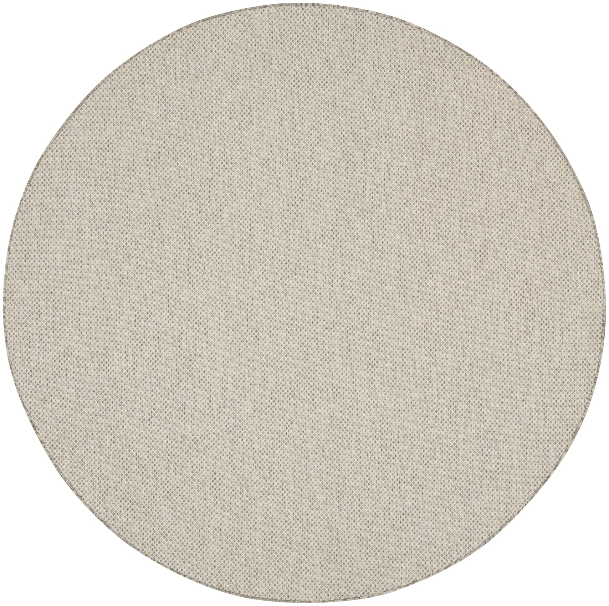 Beige circular fabric speaker grille with fine perforated texture.