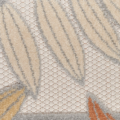 Close-up of beige-gray textured rug with raised cream wave patterns and orange accents.